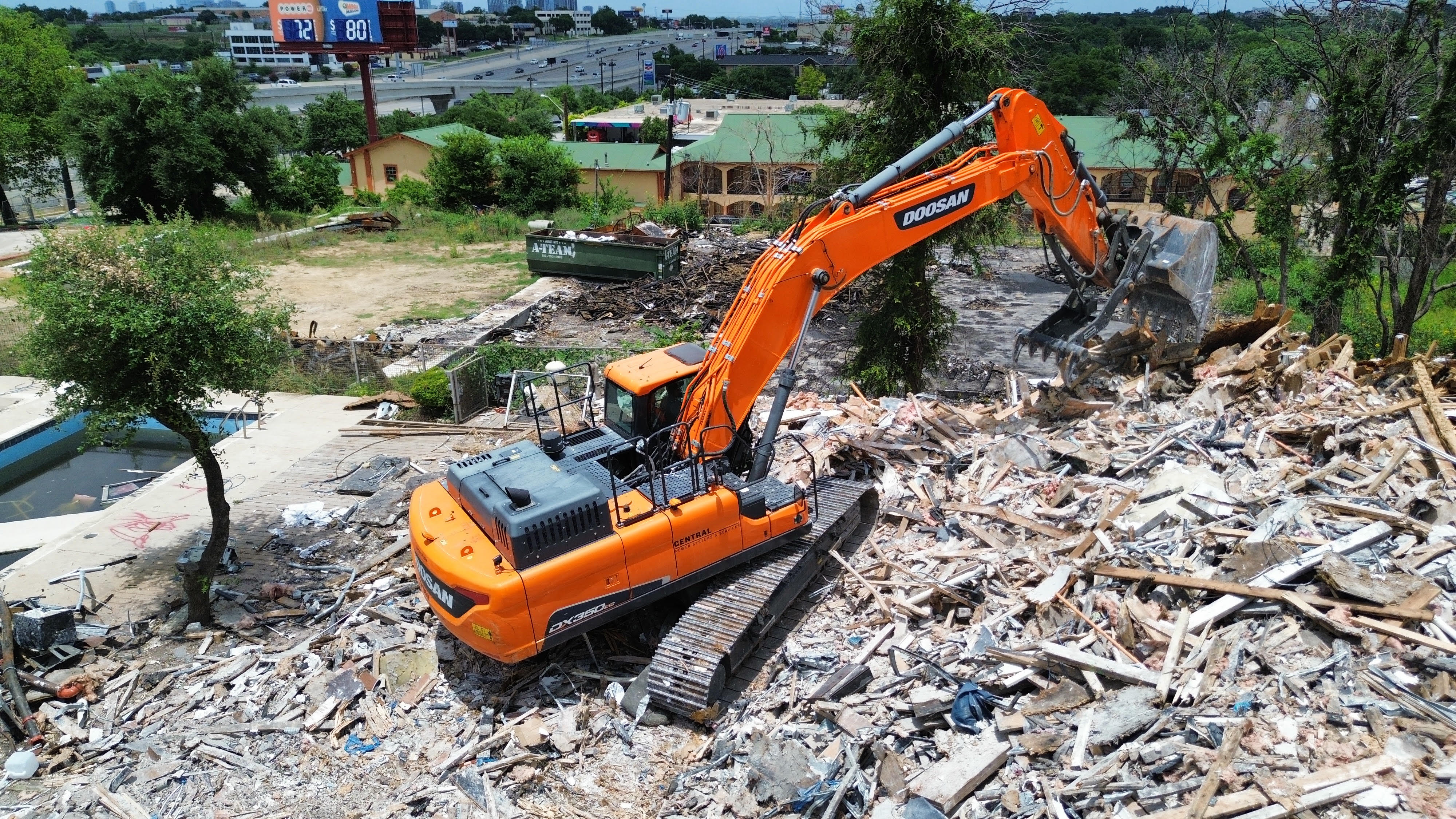 Excavator performing demolition work