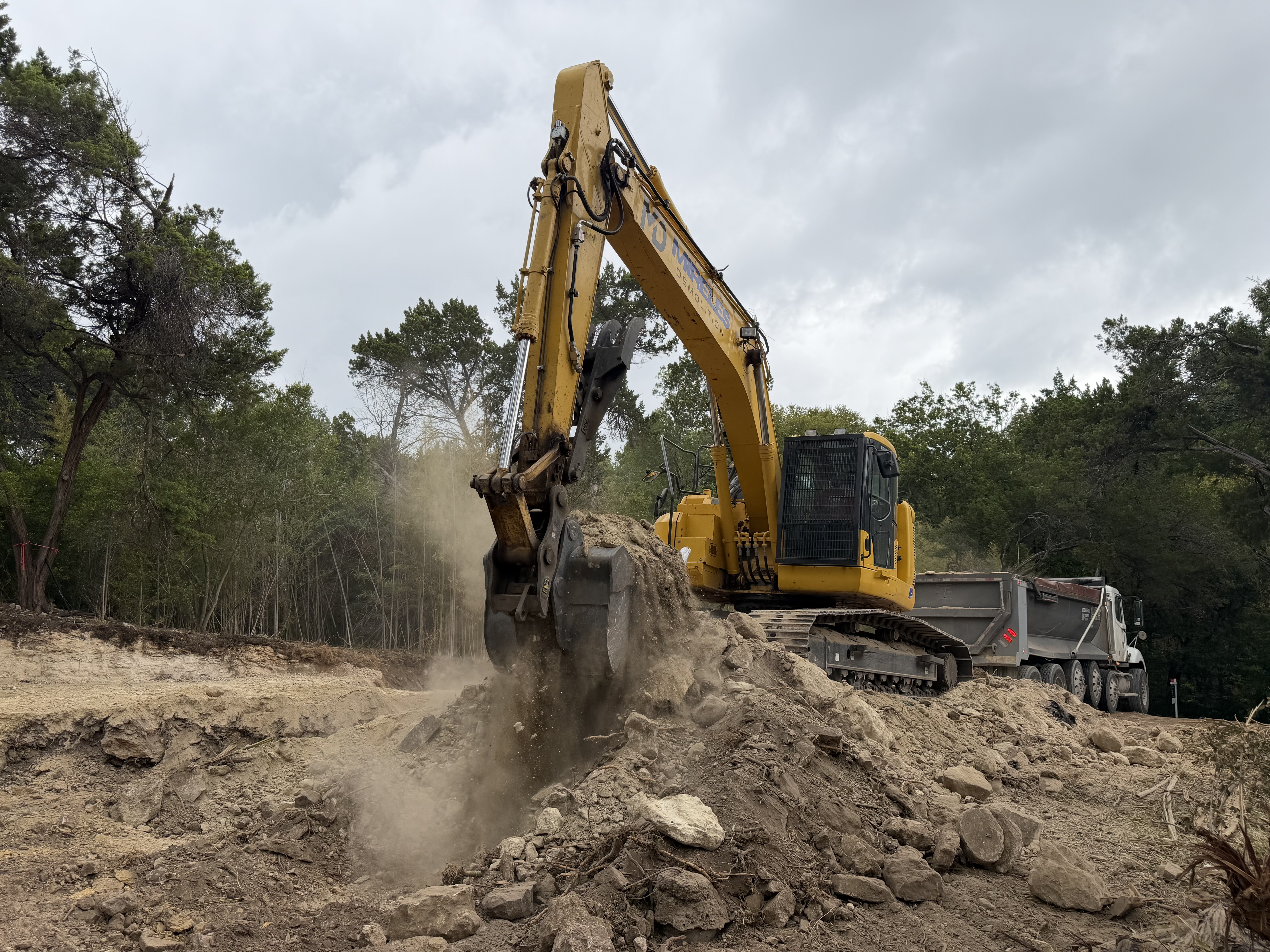 Mireles Demolition excavator actively moving earth at an excavation project