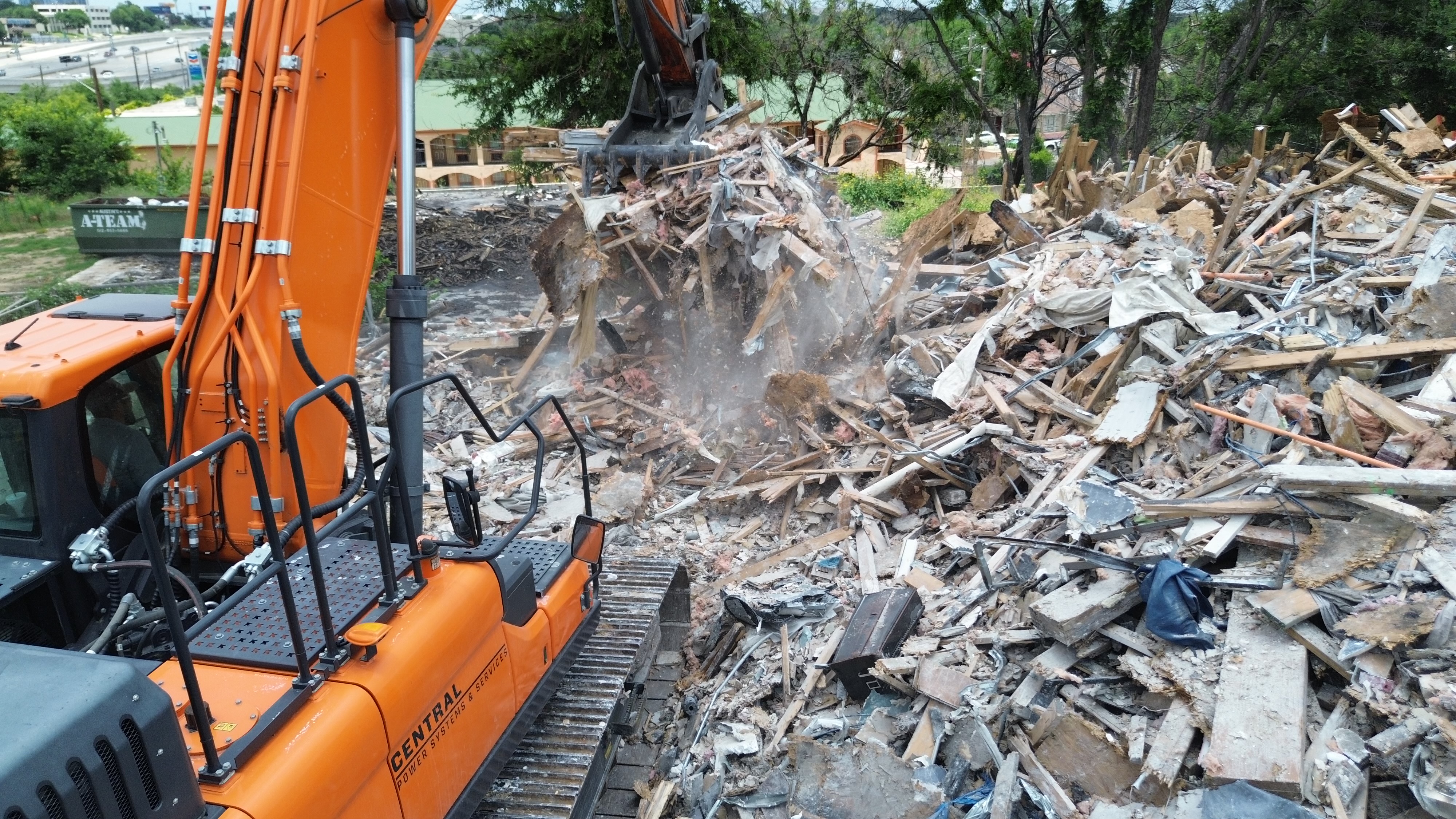 Excavator working on commercial demolition debris