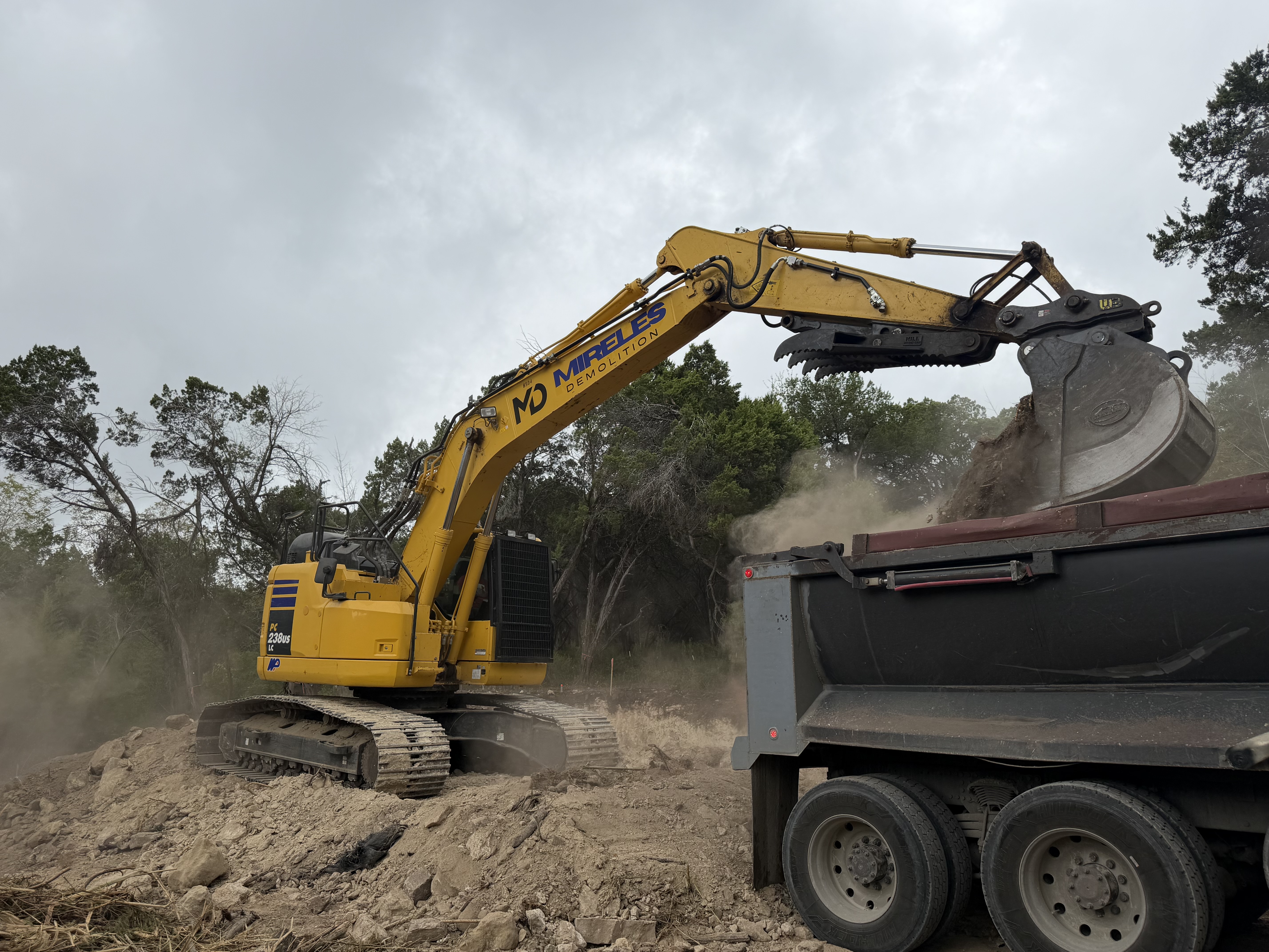Mireles Demolition excavator loading material into a truck